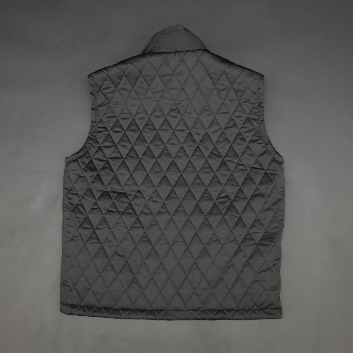 Lightweight black quilted sleeveless  puffer vest with zip closure, side and inside pockets, ideal for layering