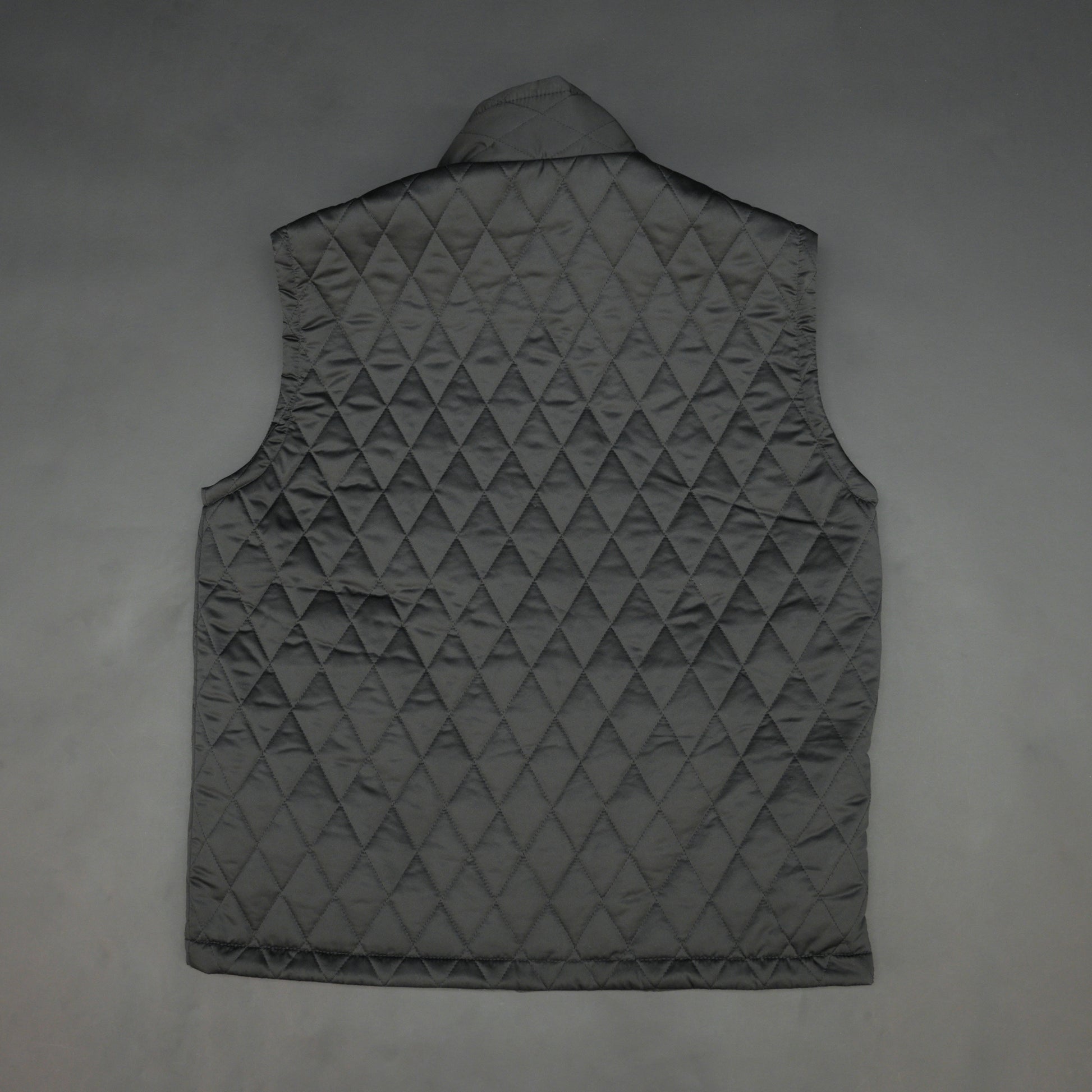 Lightweight black quilted sleeveless  puffer vest with zip closure, side and inside pockets, ideal for layering