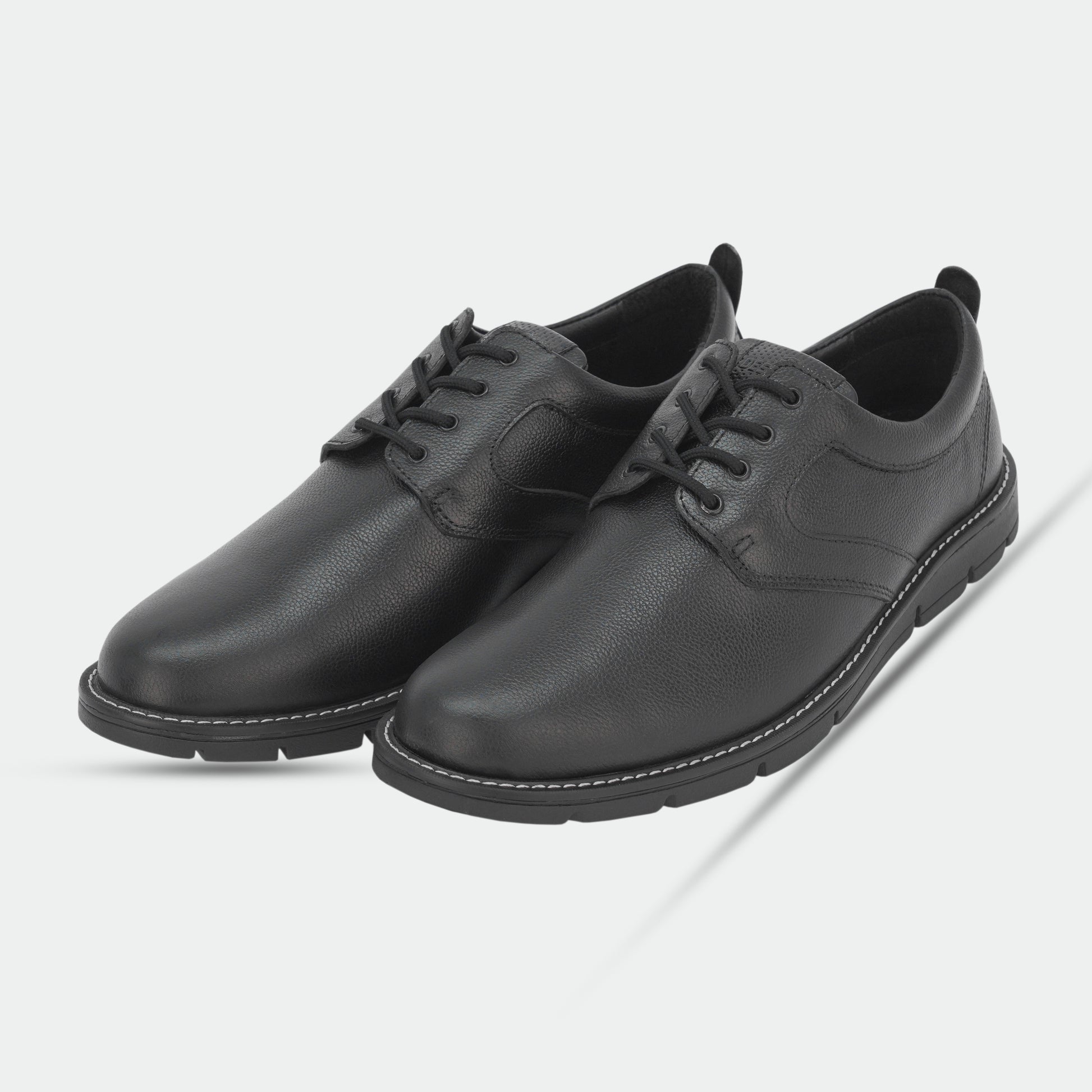 Black footwear featuring genuine cow leather milled commute upper, soft sheep lining, Taxon insole for stability, and lightweight EVA sole for comfort and grip