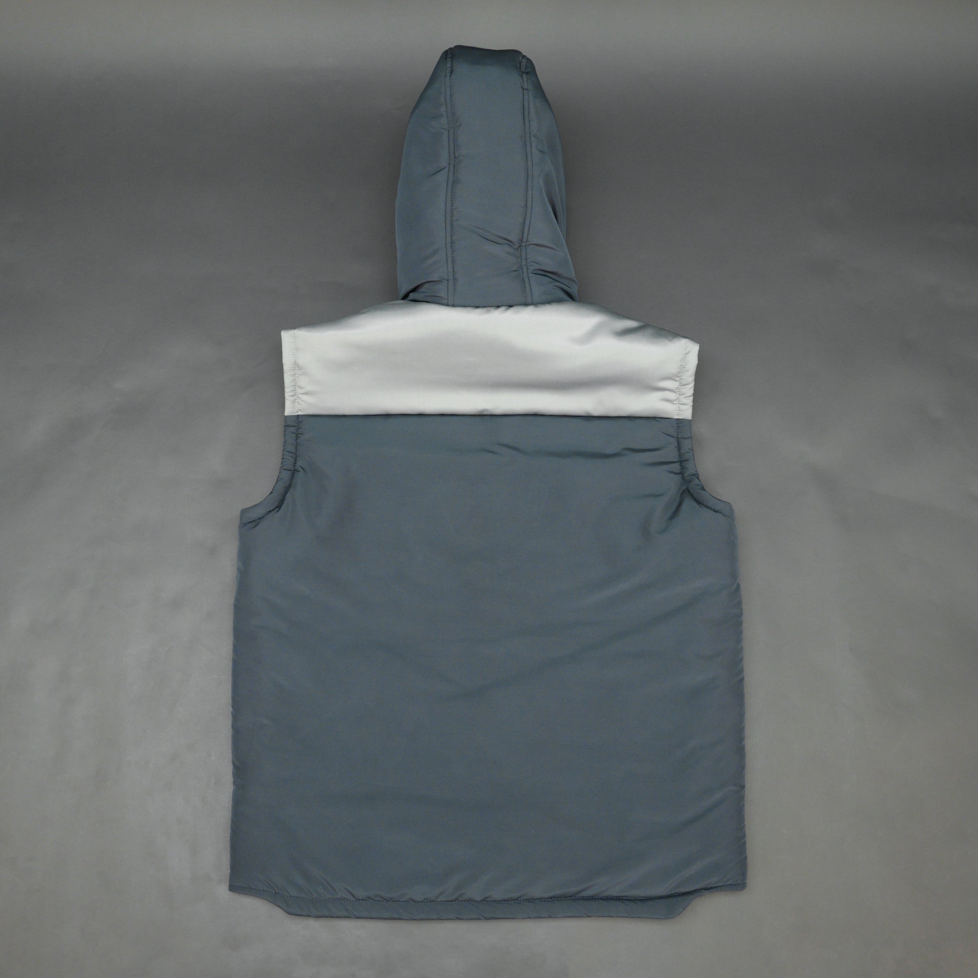 Navy-grey sleeveless puffer jacket with zip and snap closure, hood, side and inner pockets, premium fabric for warmth.