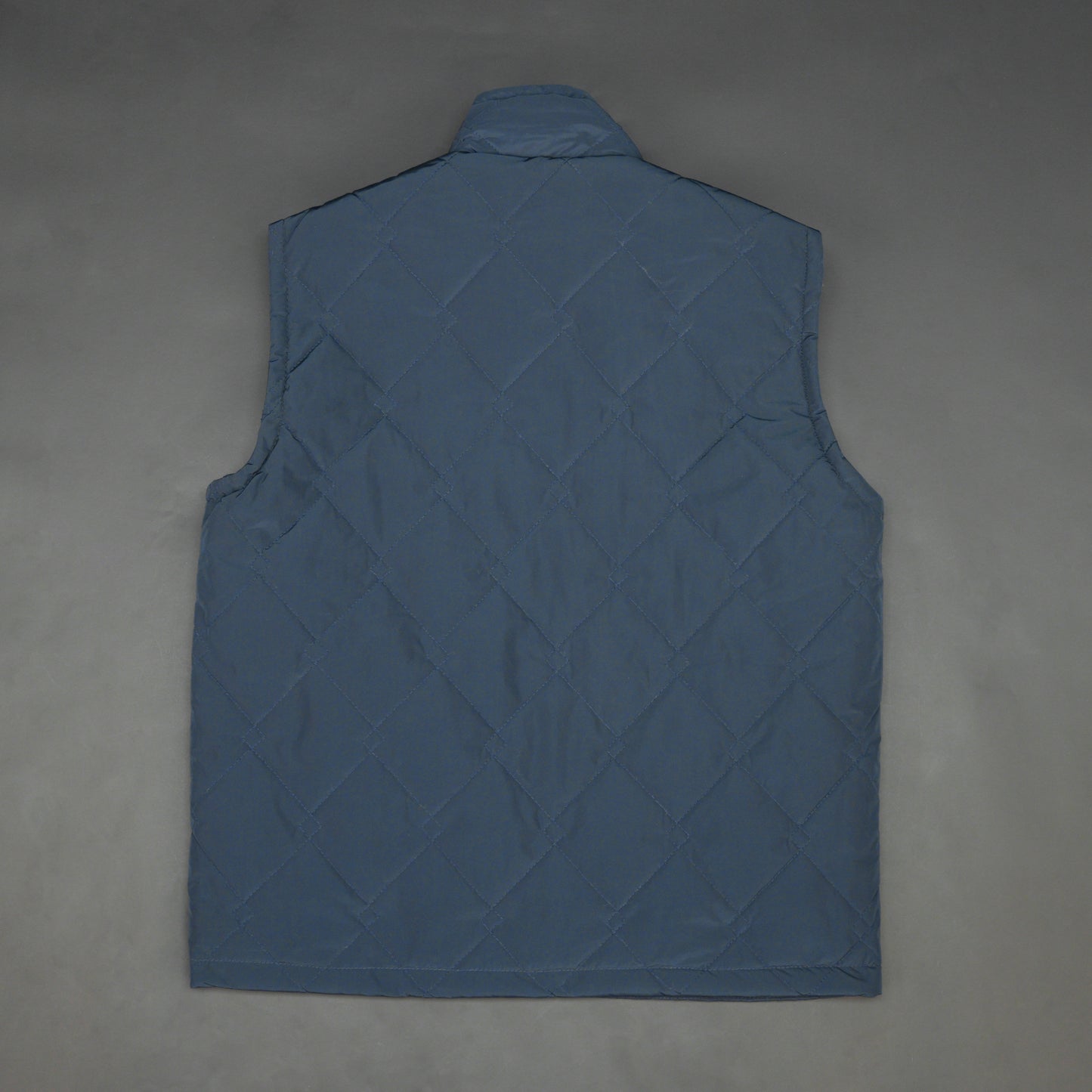 Lightweight navy sleeveless puffer vest with zip closure, side and inside pockets, for layering