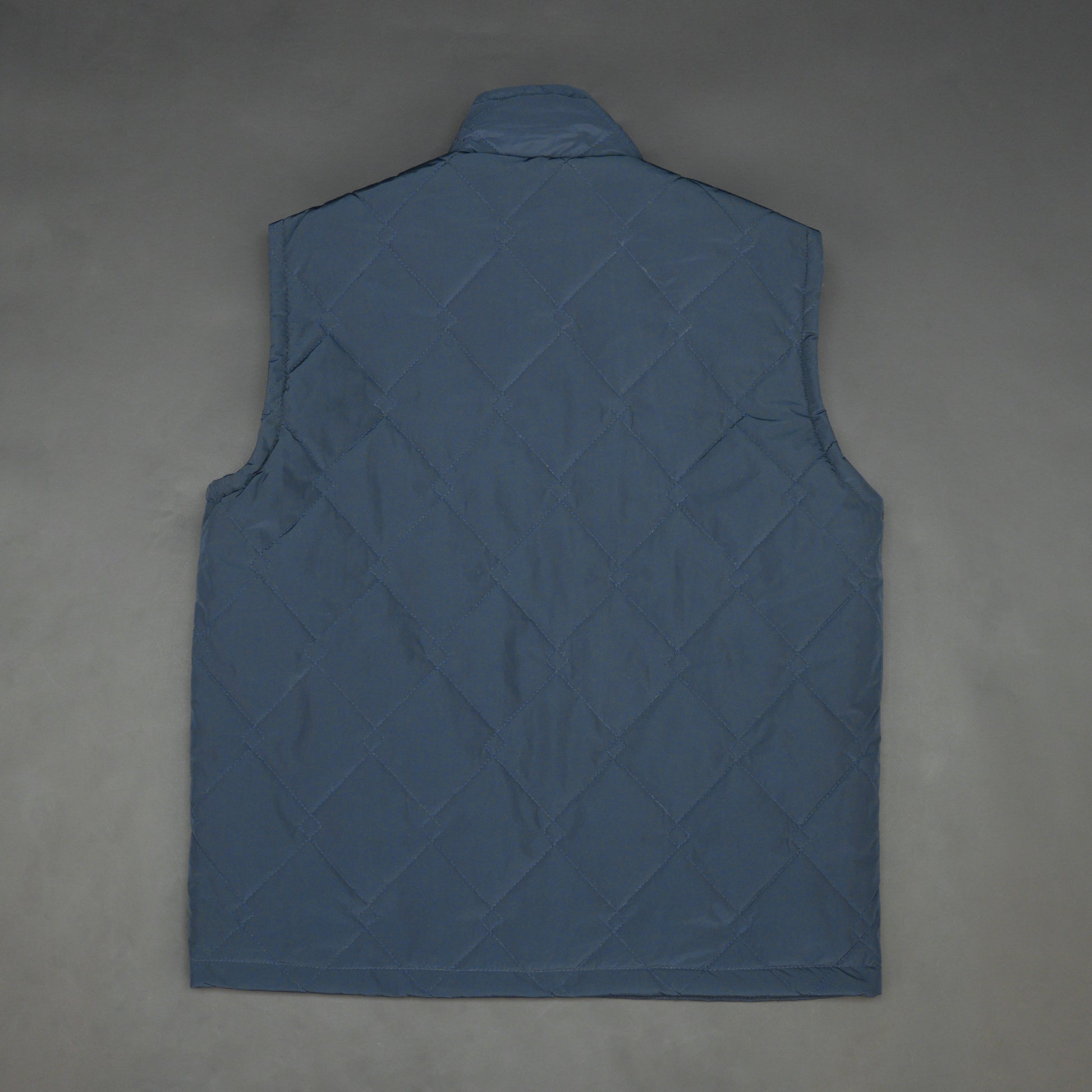 Lightweight navy sleeveless puffer vest with zip closure, side and inside pockets, for layering