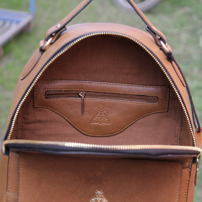 Tan genuine cowhide leather bag with minimalist design, featuring secure closures, spacious interior, and adjustable straps — crafted for durability and style