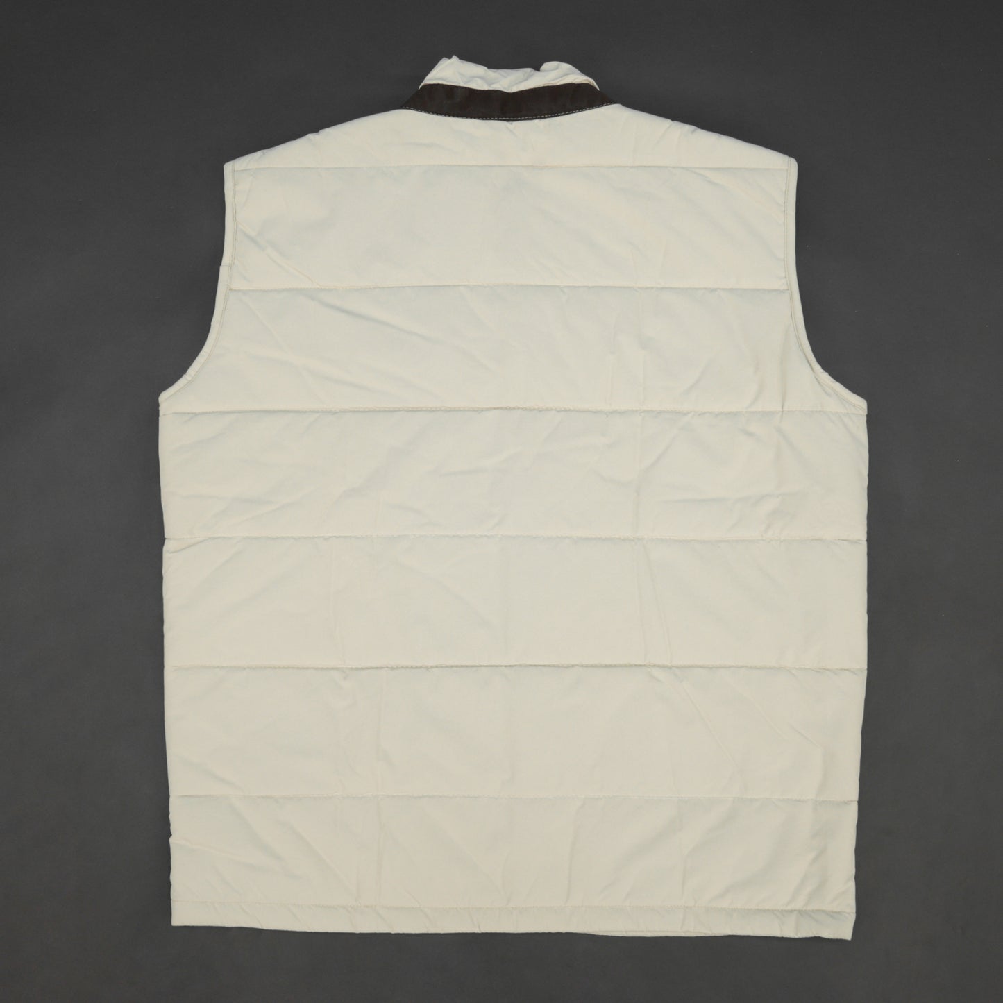 Beige jacket featuring a button closure, two snap-button side pockets, and one inner pocket for convenient, secure storage