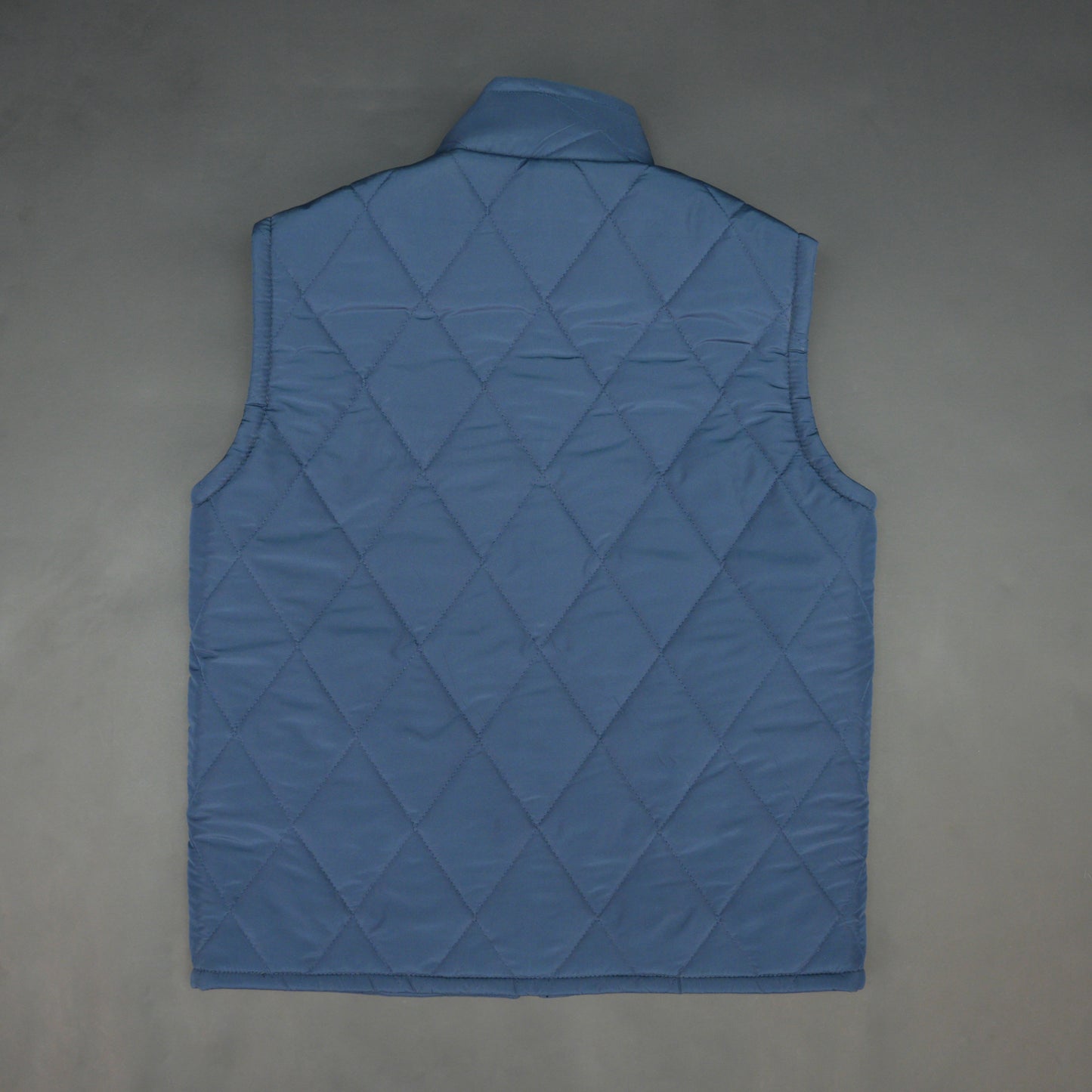 Blue sleeveless puffer vest with zip, side and inside pockets, lightweight for layering