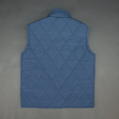 Blue sleeveless puffer vest with zip, side and inside pockets, lightweight for layering
