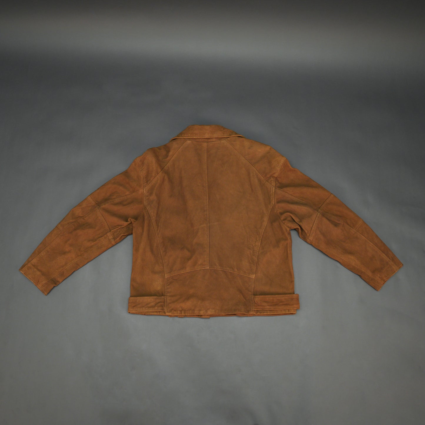 Light brown goat suede perfecto jacket with leather-look finish, soft texture, three exterior pockets, side zip pocket, and adjustable zipped cuffs. Minor fault, no returns