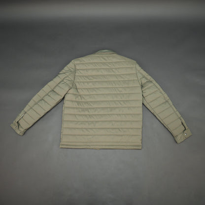 Green full-sleeve puffer jacket with snap closure, quilted padding, inner and outer pockets, designed for everyday comfort.