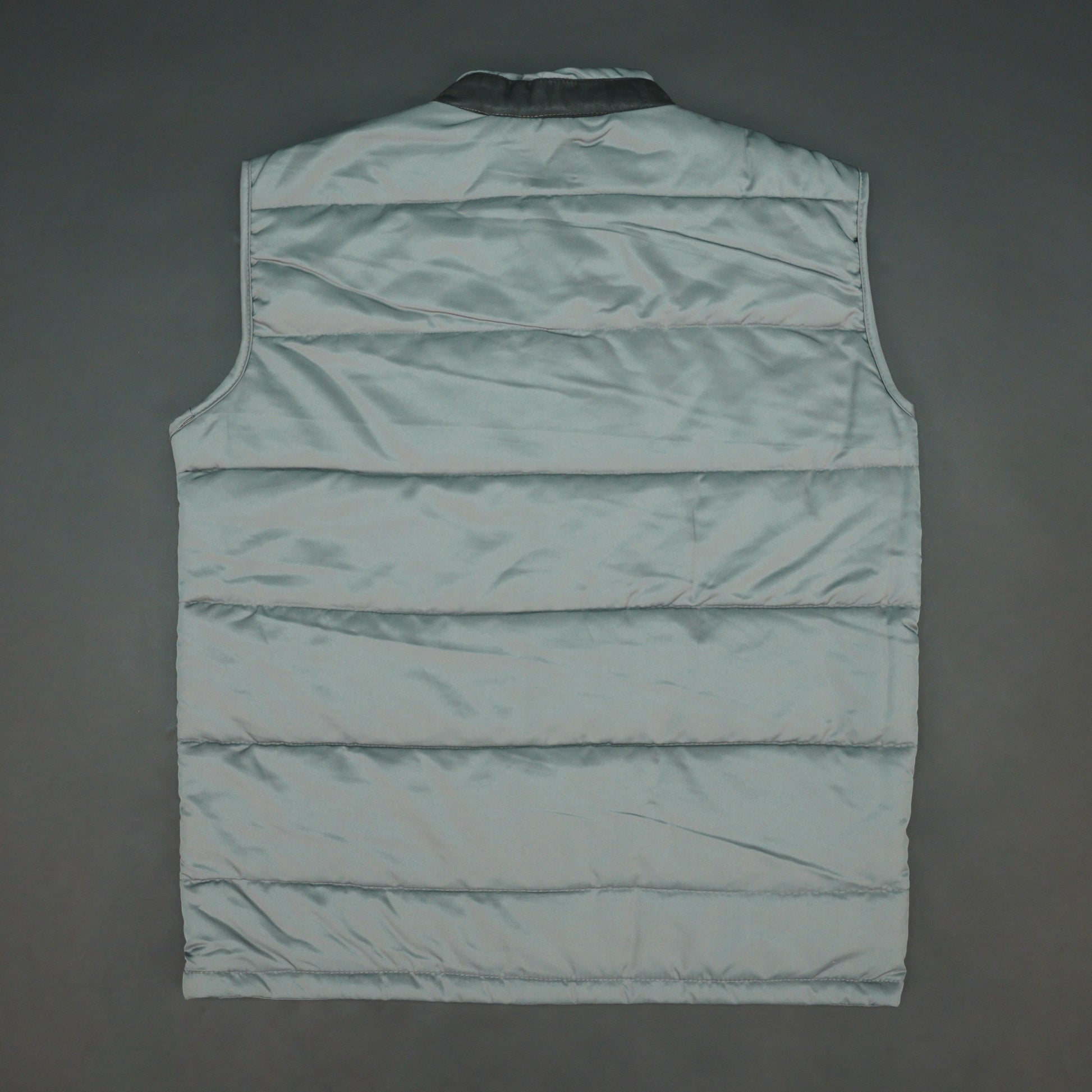 Grey jacket with a button closure, snap-button side pockets, and a single inner pocket for easy and secure storage