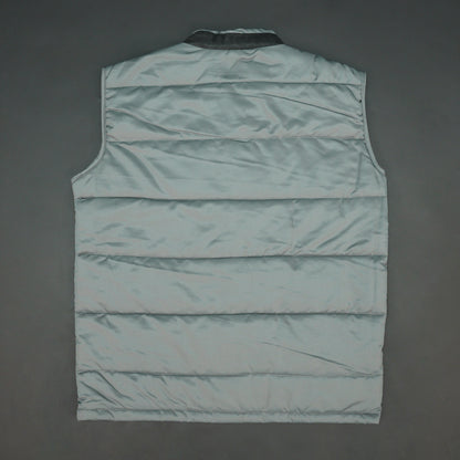 Grey jacket with a button closure, snap-button side pockets, and a single inner pocket for easy and secure storage