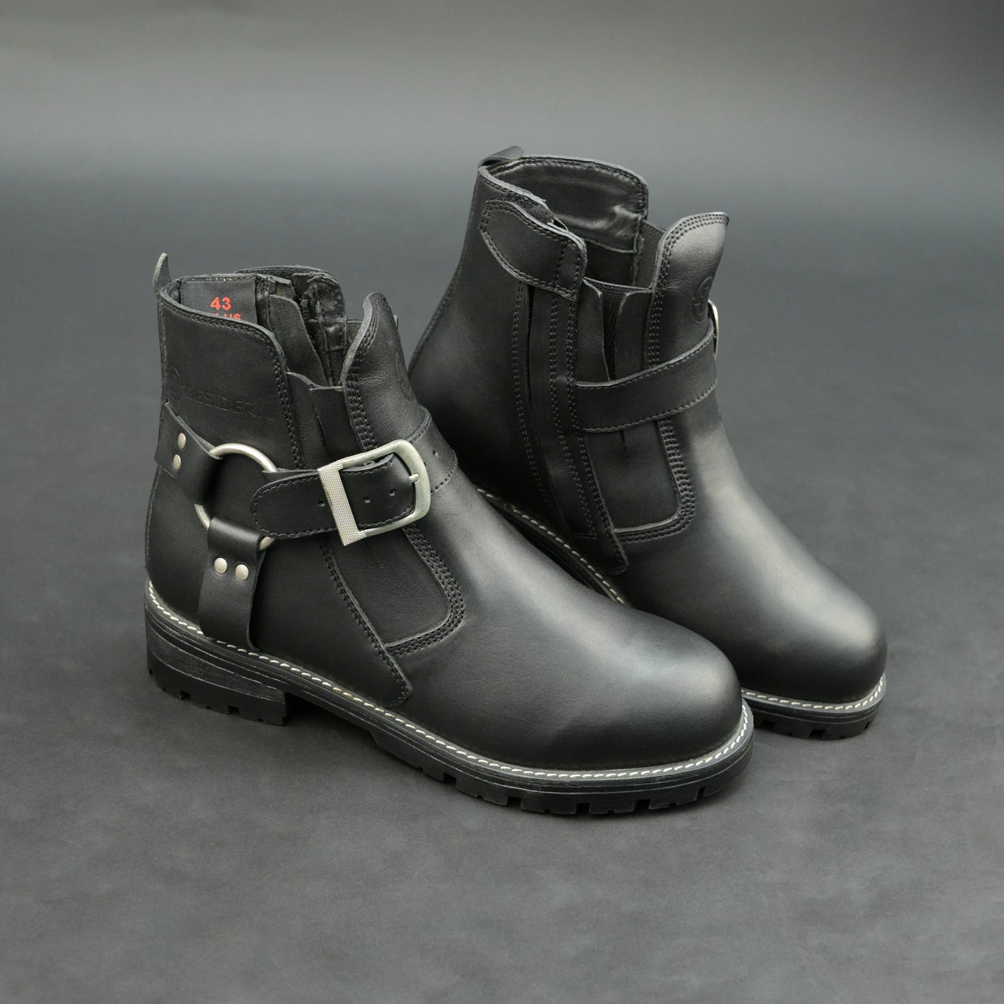 Matte black bovine leather biker boots with side buckle and zipper.