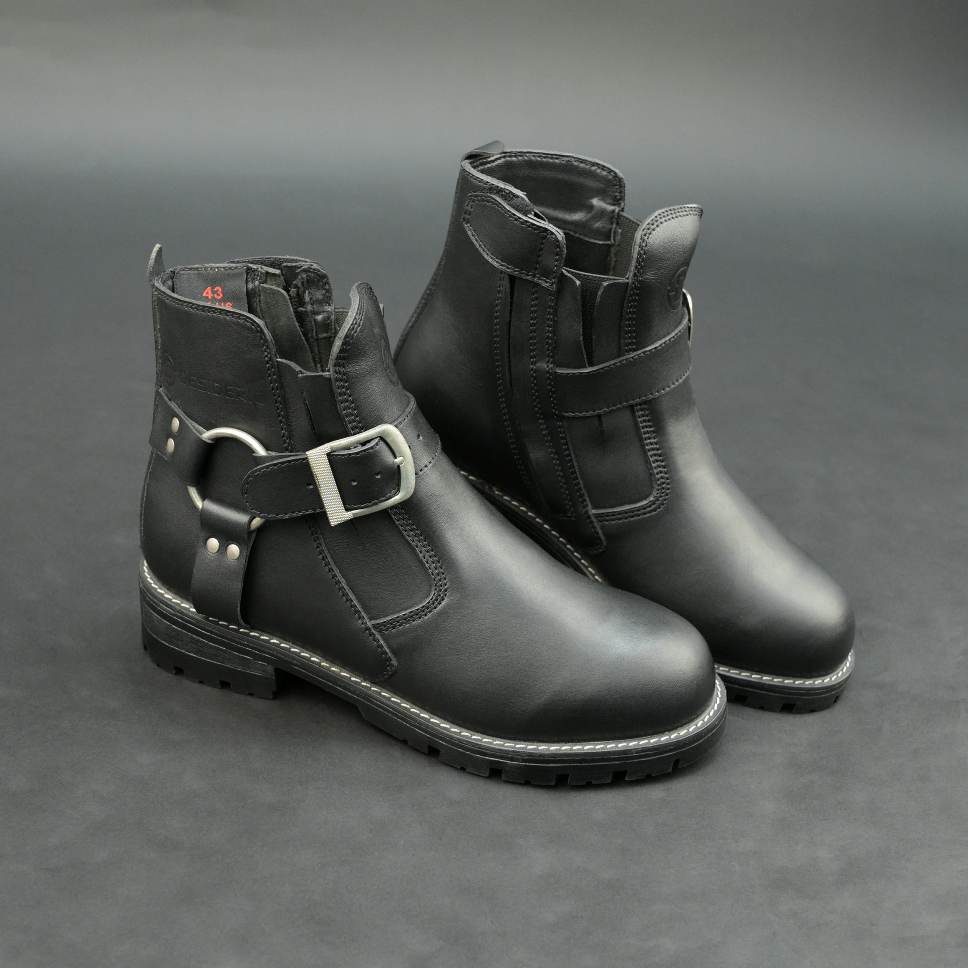 Matte black bovine leather biker boots with side buckle and zipper.