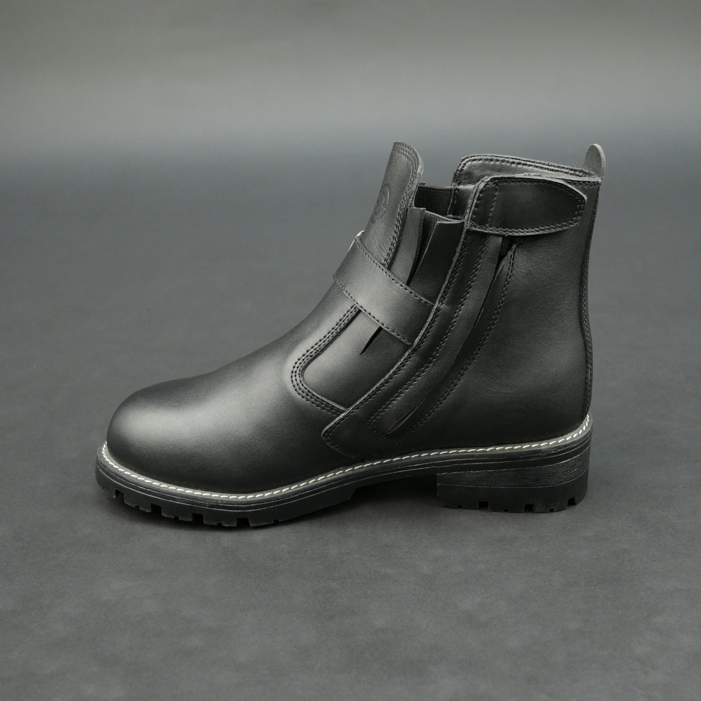 Matte black bovine leather biker boots with side buckle and zipper.