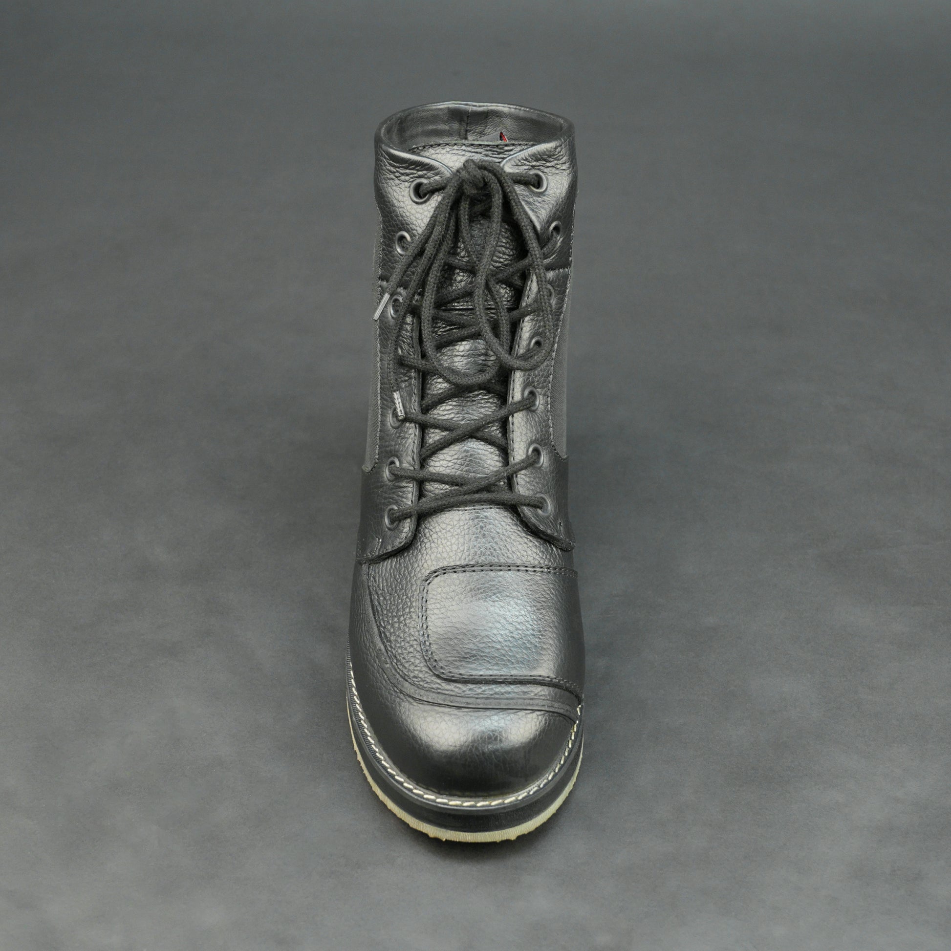 Black high-ankle motorbike boots with mesh panels.