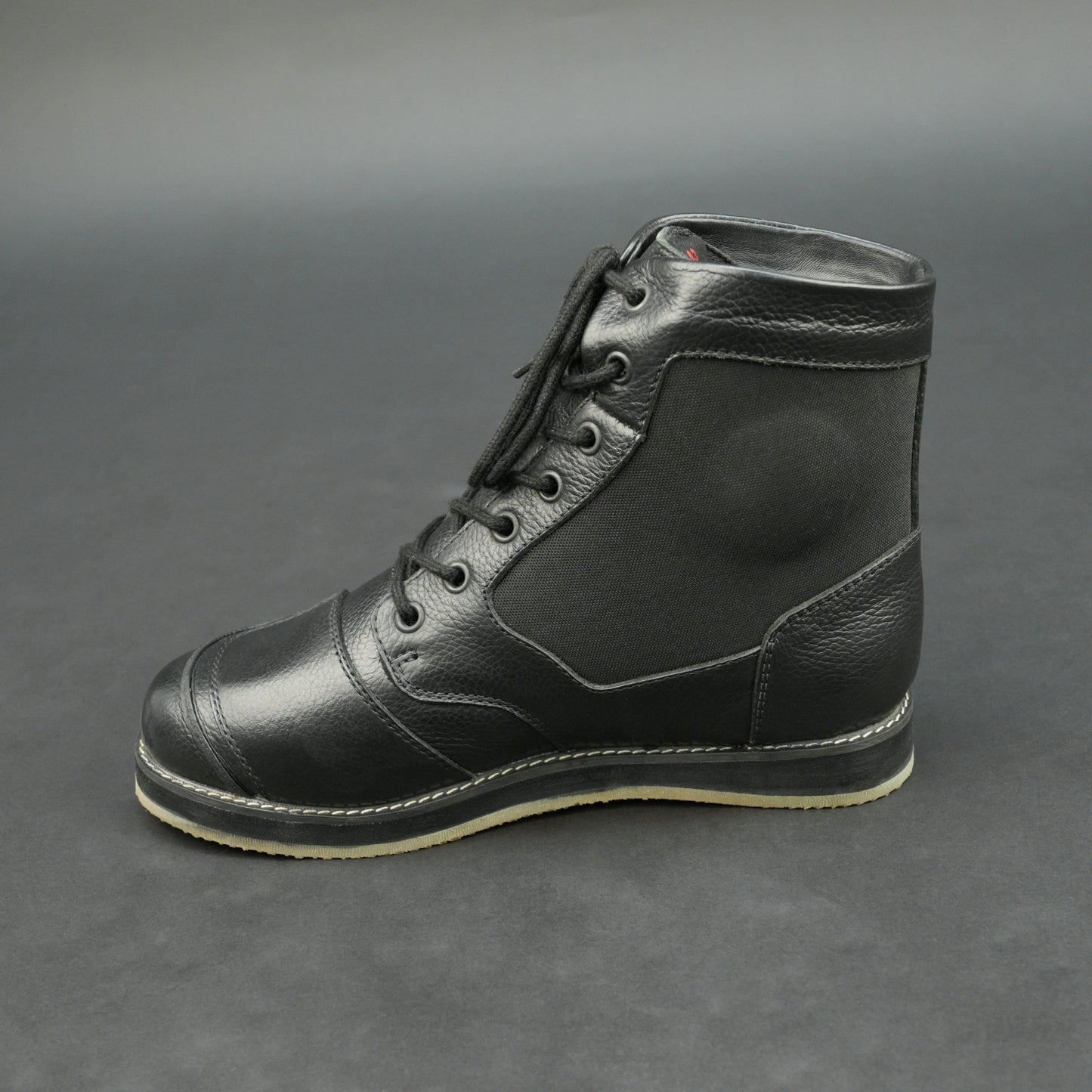 Black high-ankle motorbike boots with mesh panels.