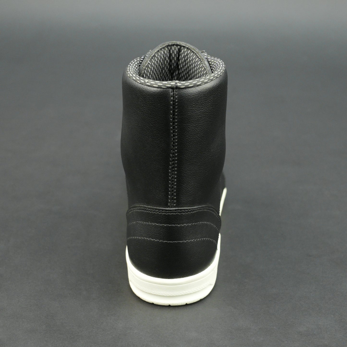 Black high-top leather sneakers with white sole.