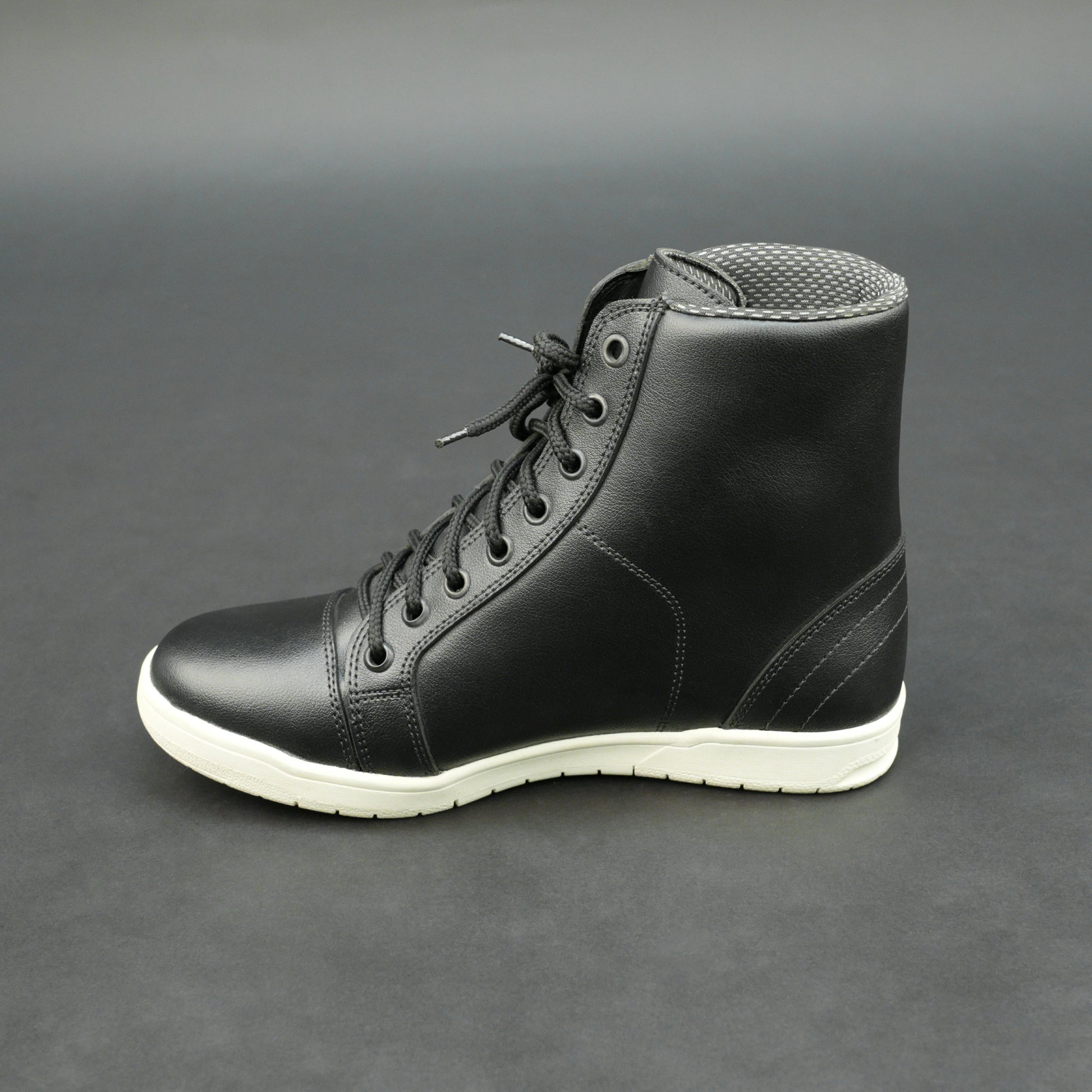 Black high-top leather sneakers with white sole.