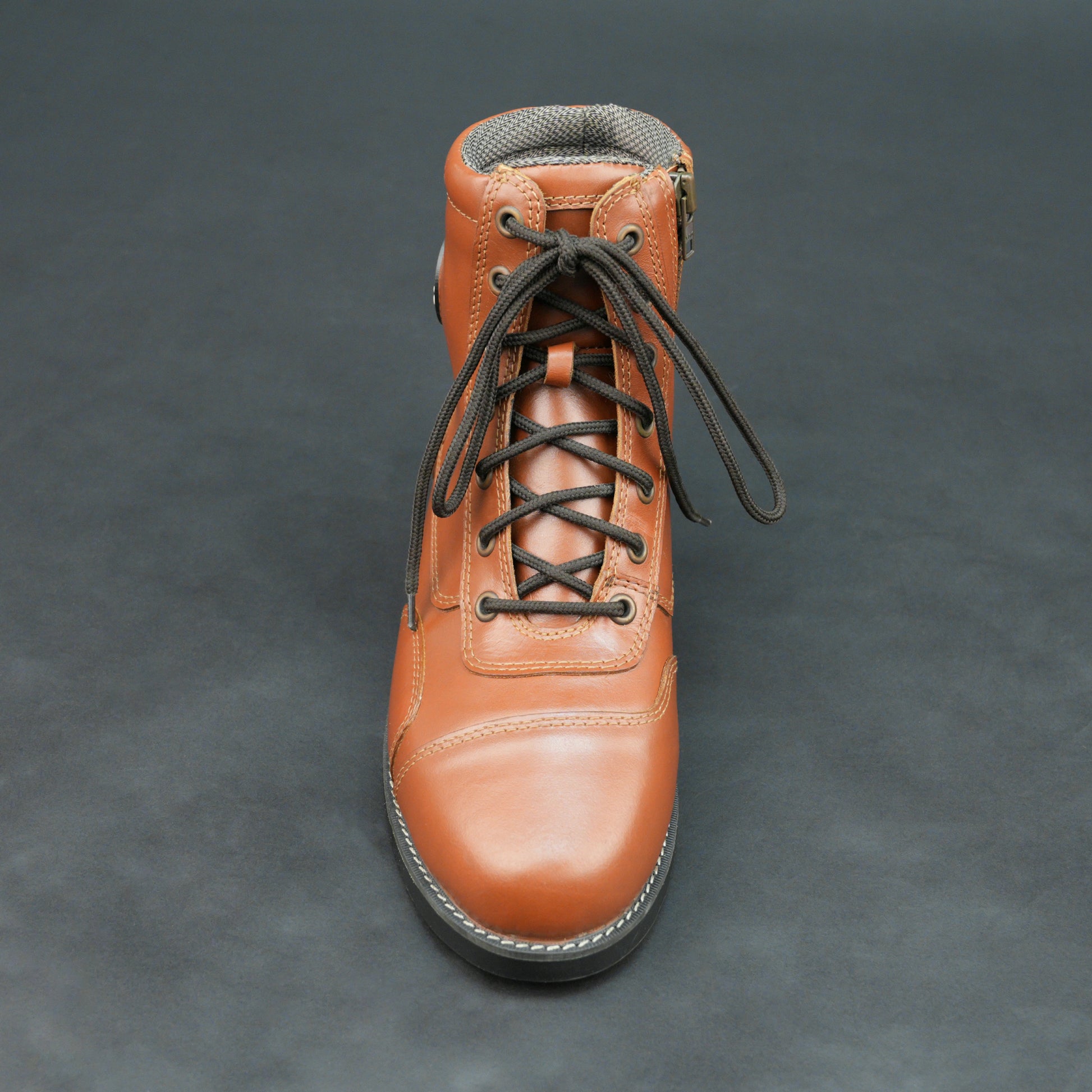 Brown bovine leather motorbike boots with side zipper and black laces.