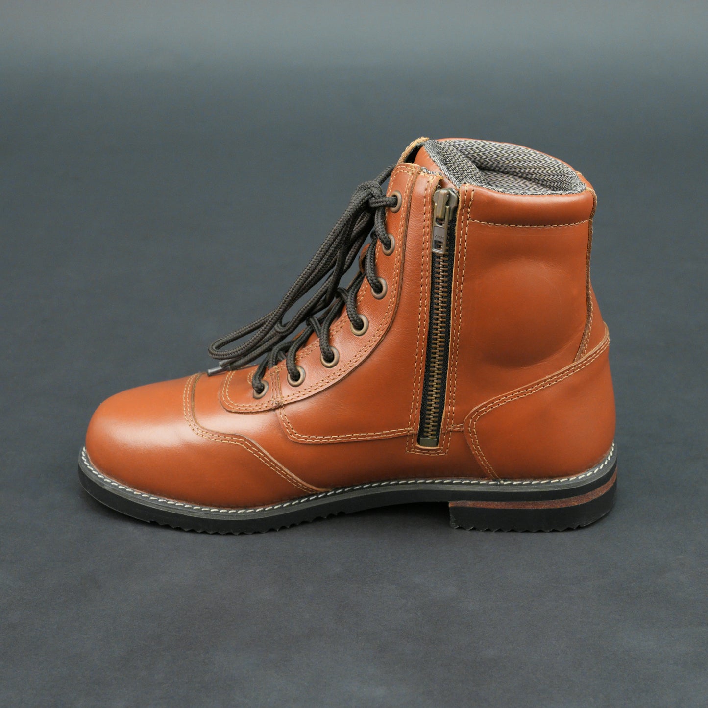Brown bovine leather motorbike boots with side zipper and black laces.