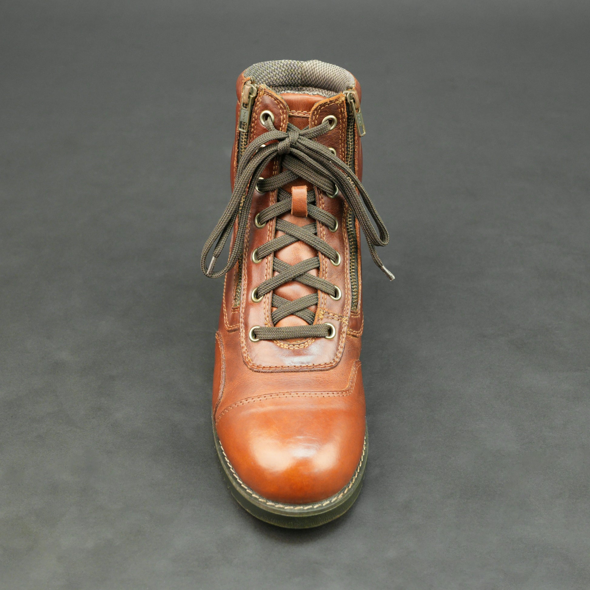 Cognac brown bovine leather motorbike boots with side zipper and lace-up design.