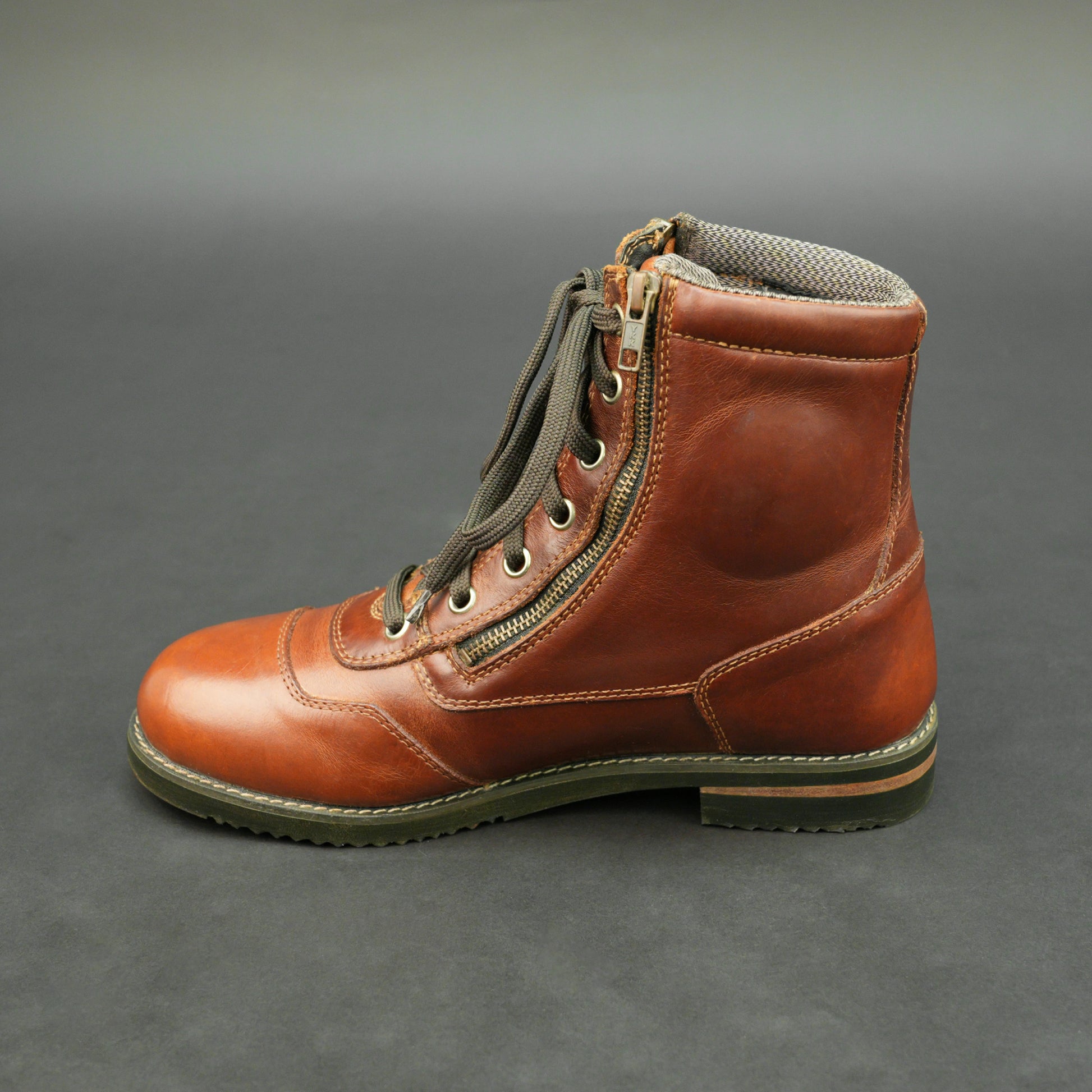 Cognac brown bovine leather motorbike boots with side zipper and lace-up design.