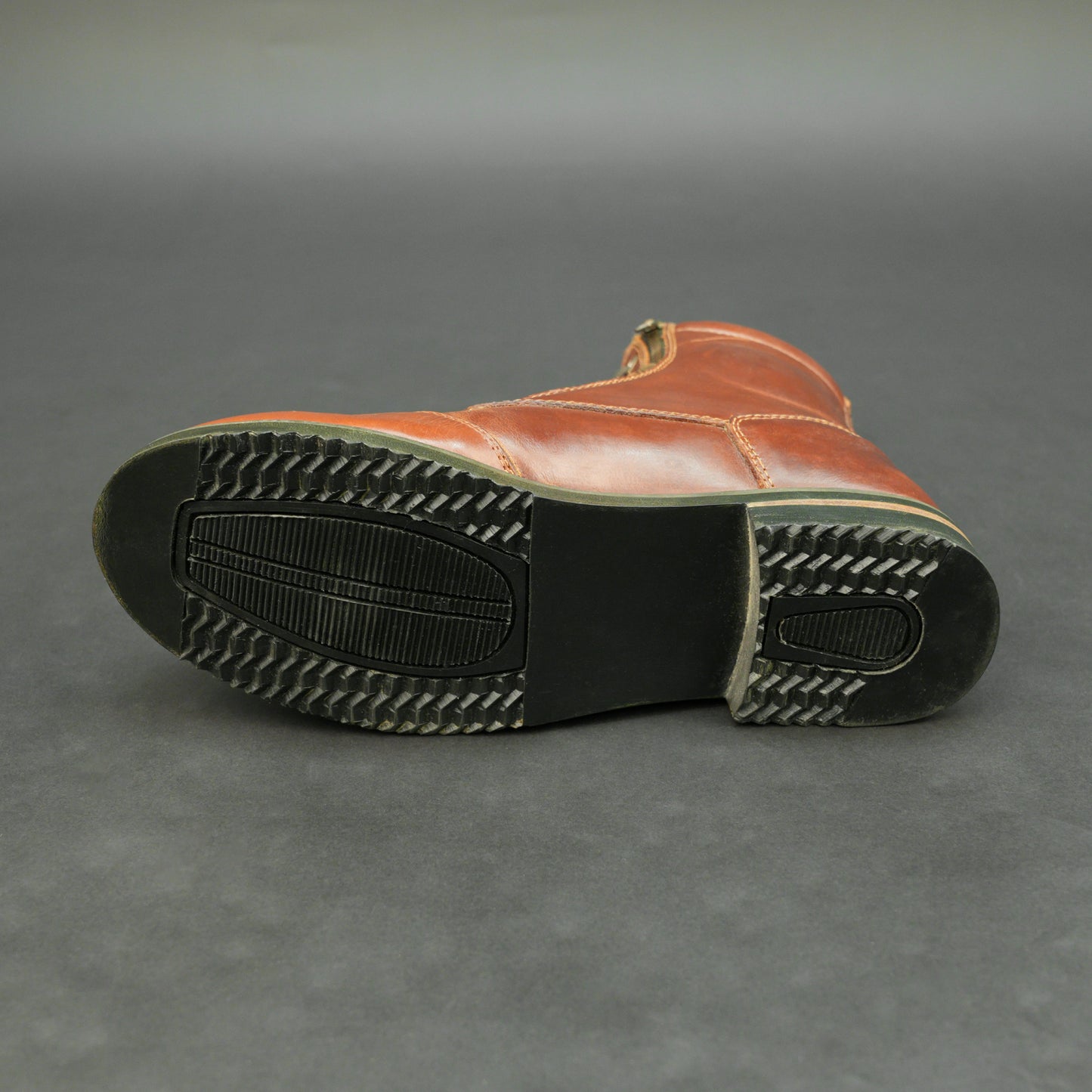Cognac brown bovine leather motorbike boots with side zipper and lace-up design.