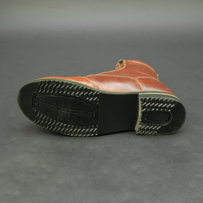 Cognac brown bovine leather motorbike boots with side zipper and lace-up design.