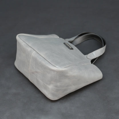 Premium grey cow vachetta leather bag with spacious compartment and inner pockets.