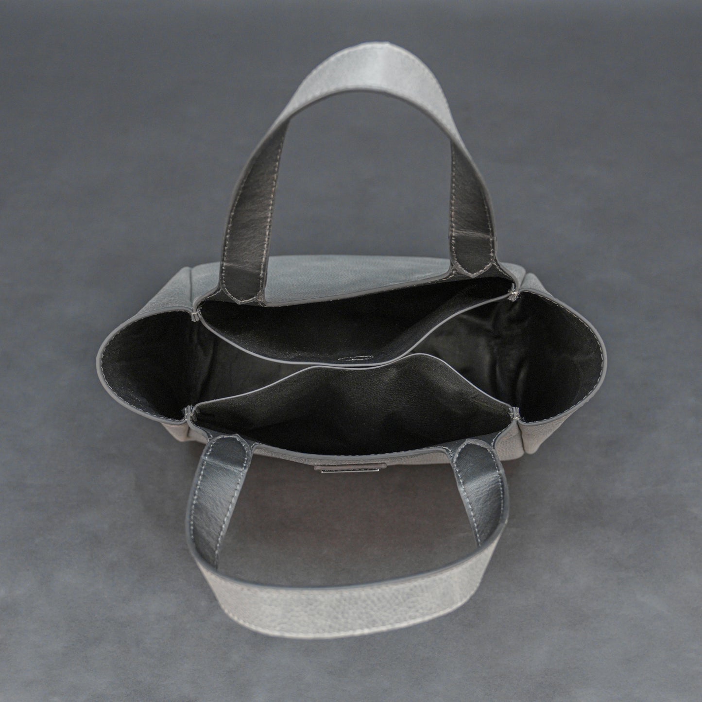 Premium grey cow vachetta leather bag with spacious compartment and inner pockets.