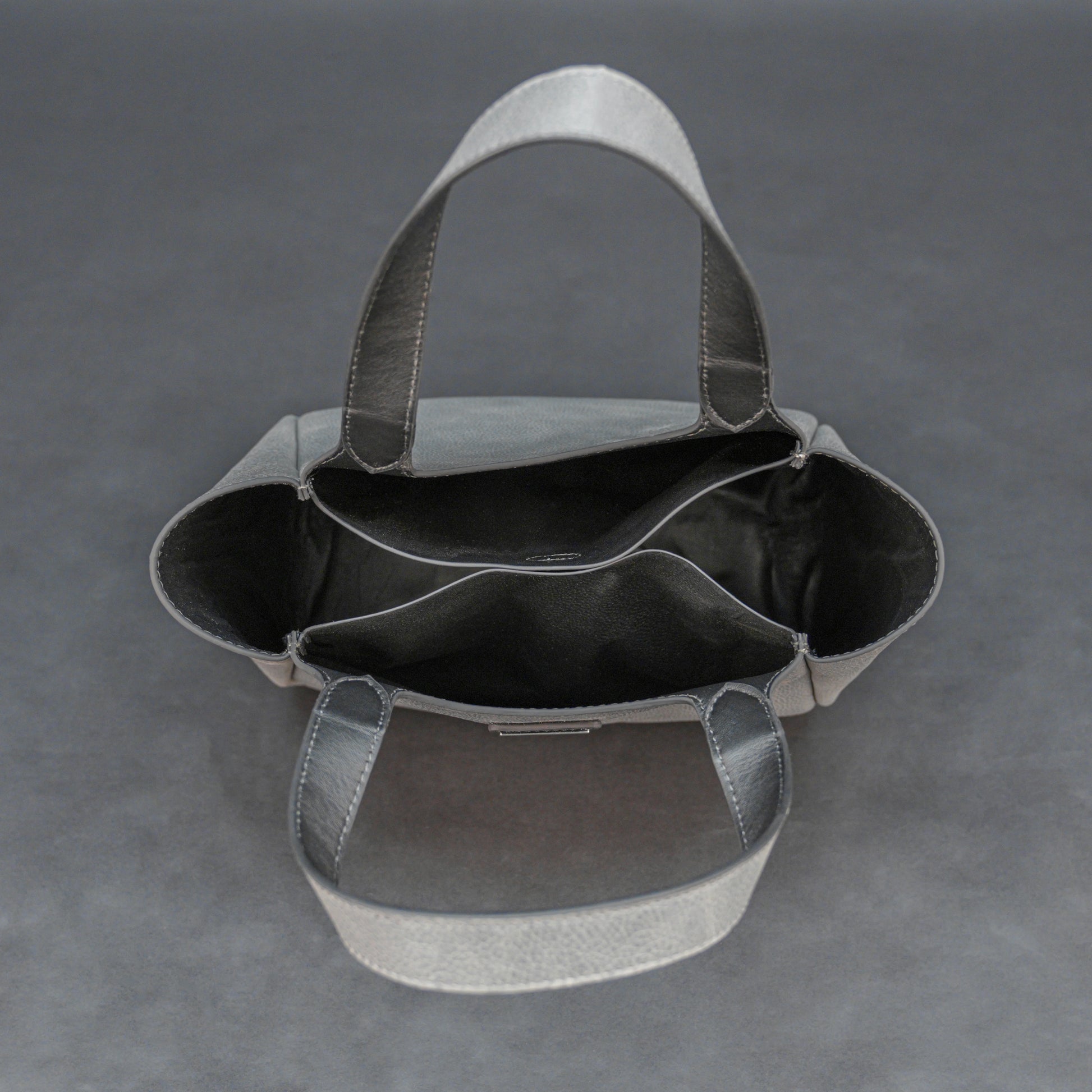 Premium grey cow vachetta leather bag with spacious compartment and inner pockets.