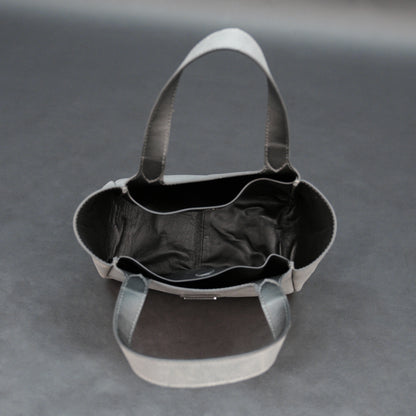 Premium grey cow vachetta leather bag with spacious compartment and inner pockets.