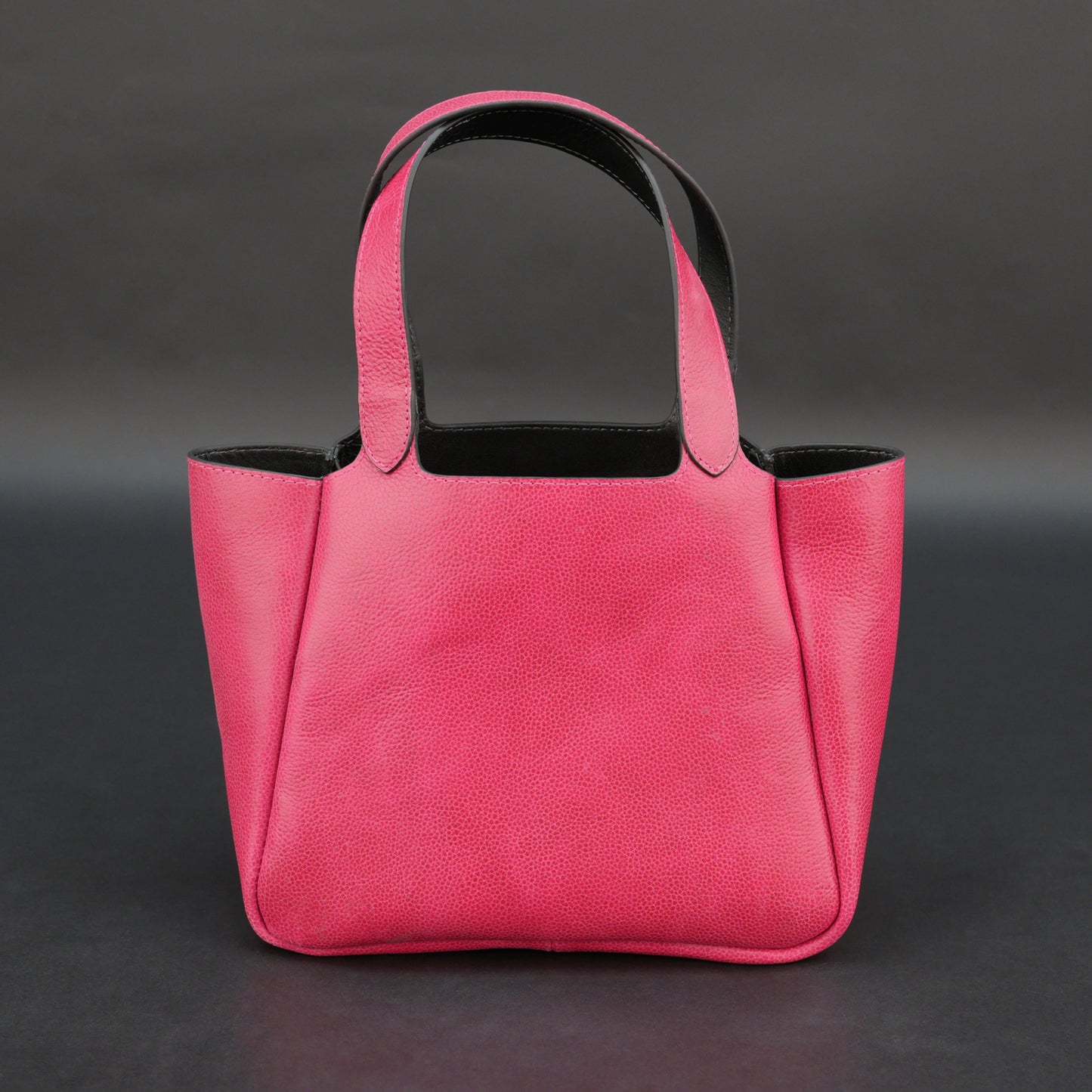Pink cow vachetta leather bag with main compartment, inner pockets, and durable everyday design.