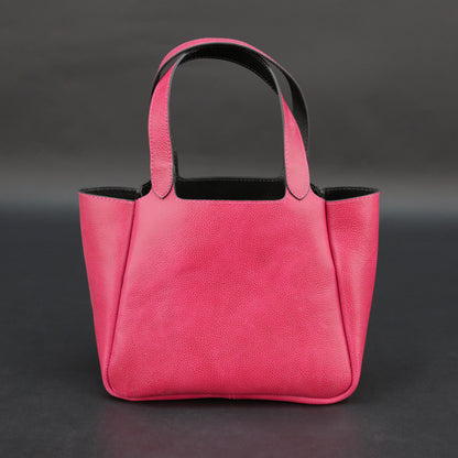 Pink cow vachetta leather bag with main compartment, inner pockets, and durable everyday design.