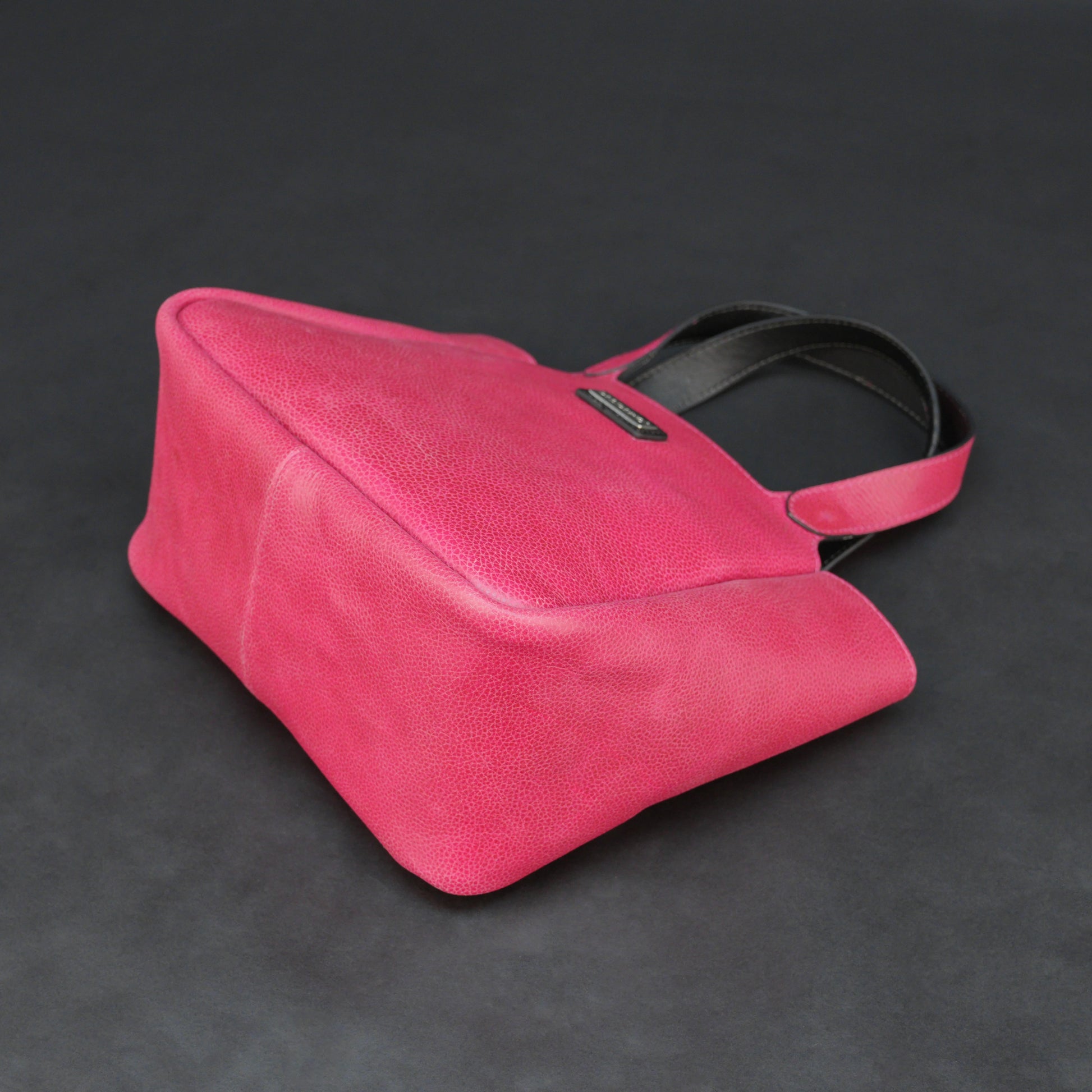 Pink cow vachetta leather bag with main compartment, inner pockets, and durable everyday design.