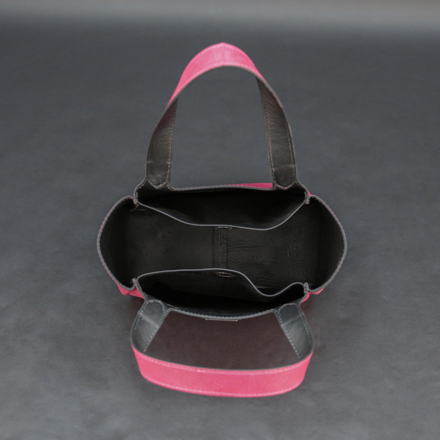 Pink cow vachetta leather bag with main compartment, inner pockets, and durable everyday design.