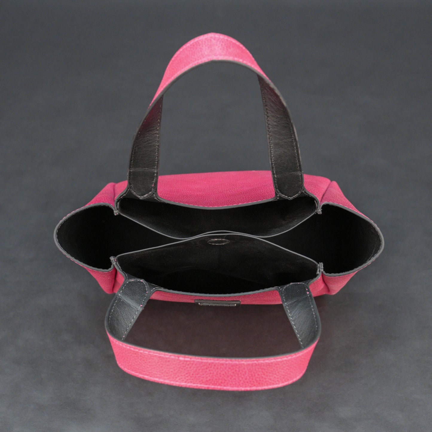 Pink cow vachetta leather bag with main compartment, inner pockets, and durable everyday design.