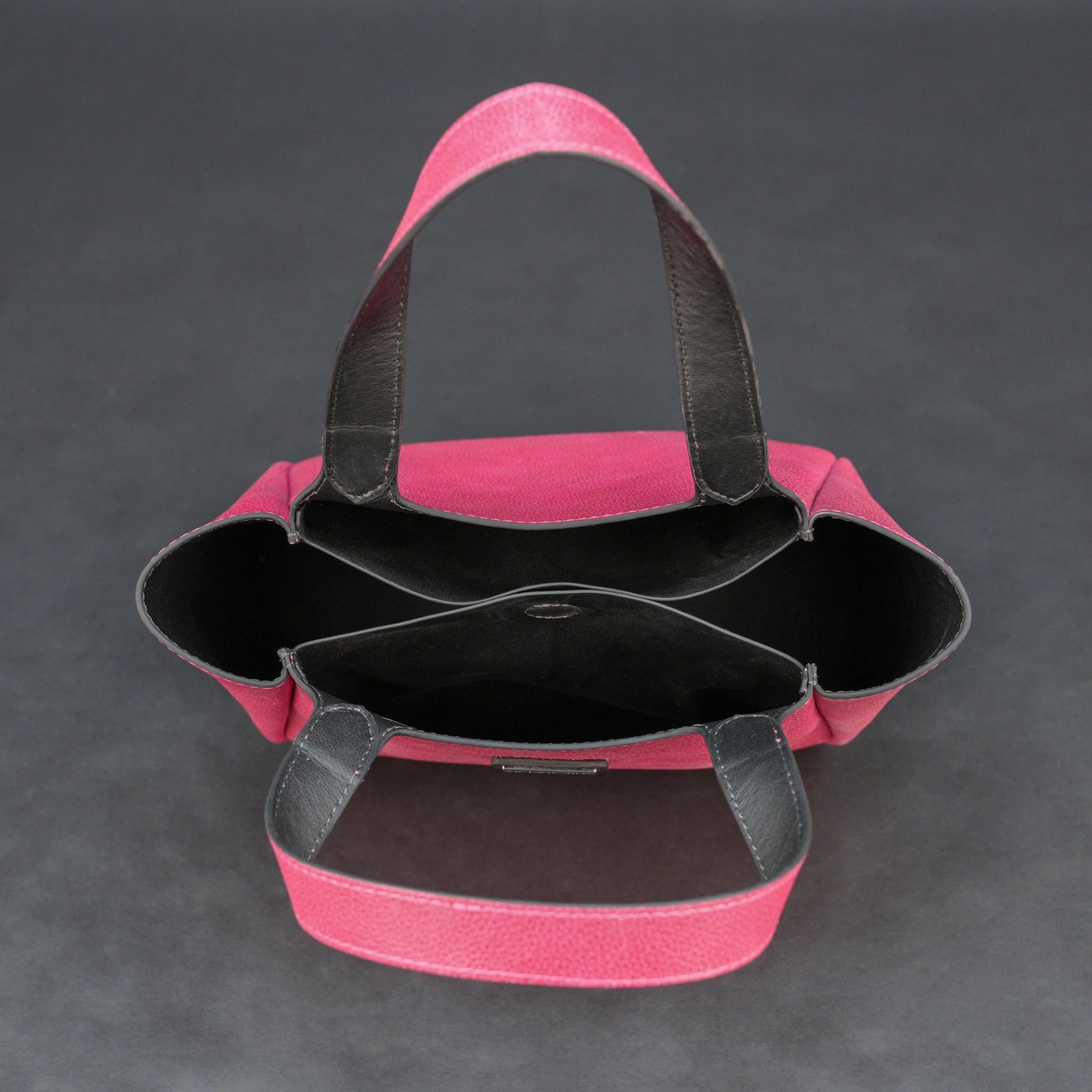 Pink cow vachetta leather bag with main compartment, inner pockets, and durable everyday design.
