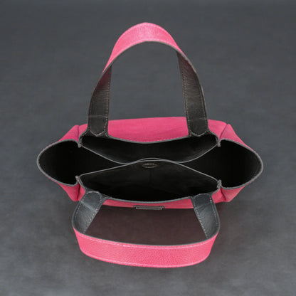 Pink cow vachetta leather bag with main compartment, inner pockets, and durable everyday design.