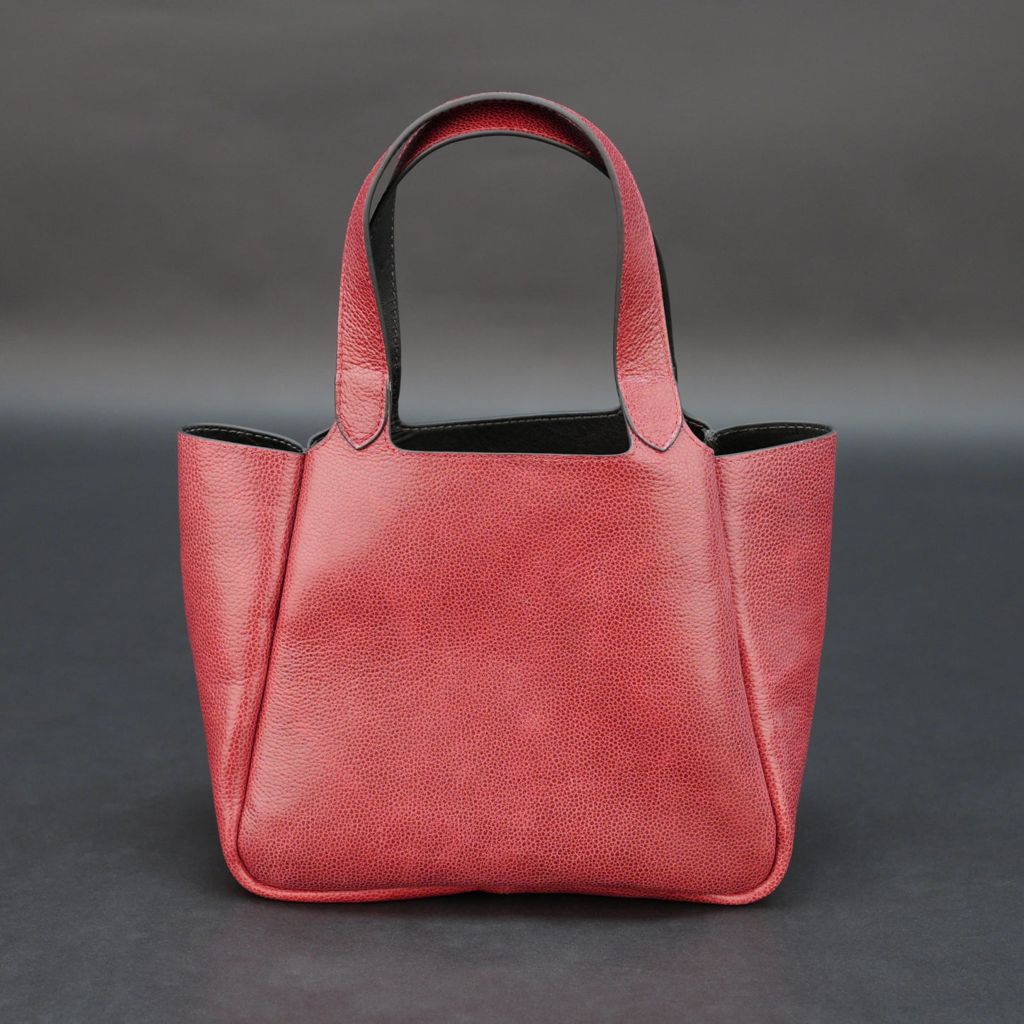 Premium red cow vachetta leather bag with spacious compartment and inner pockets.