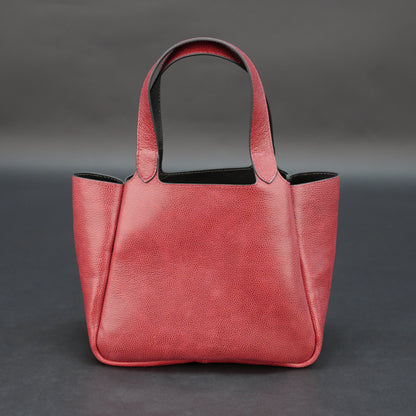 Premium red cow vachetta leather bag with spacious compartment and inner pockets.