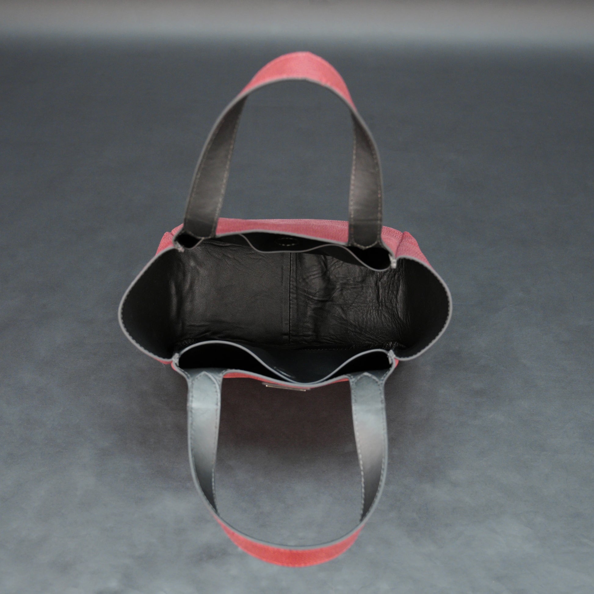 Premium red cow vachetta leather bag with spacious compartment and inner pockets.