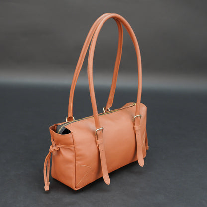 Tan cow Chelsea leather bag with shoulder strap, main compartment, and inner pockets.
