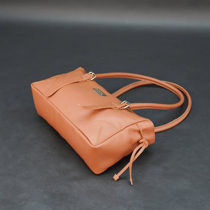 Tan cow Chelsea leather bag with shoulder strap, main compartment, and inner pockets.