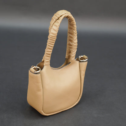 Beige cow Bamie leather bag with straps and pockets.