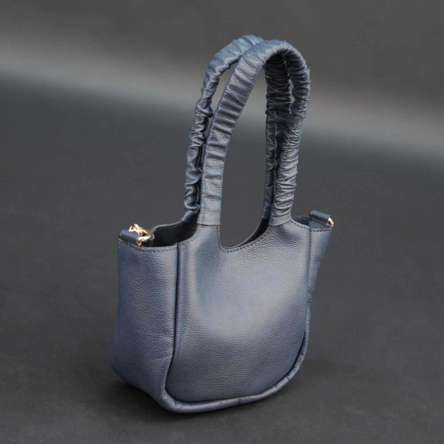Deep blue premium cow leather bag with shoulder strap, main compartment, and inner pocket.