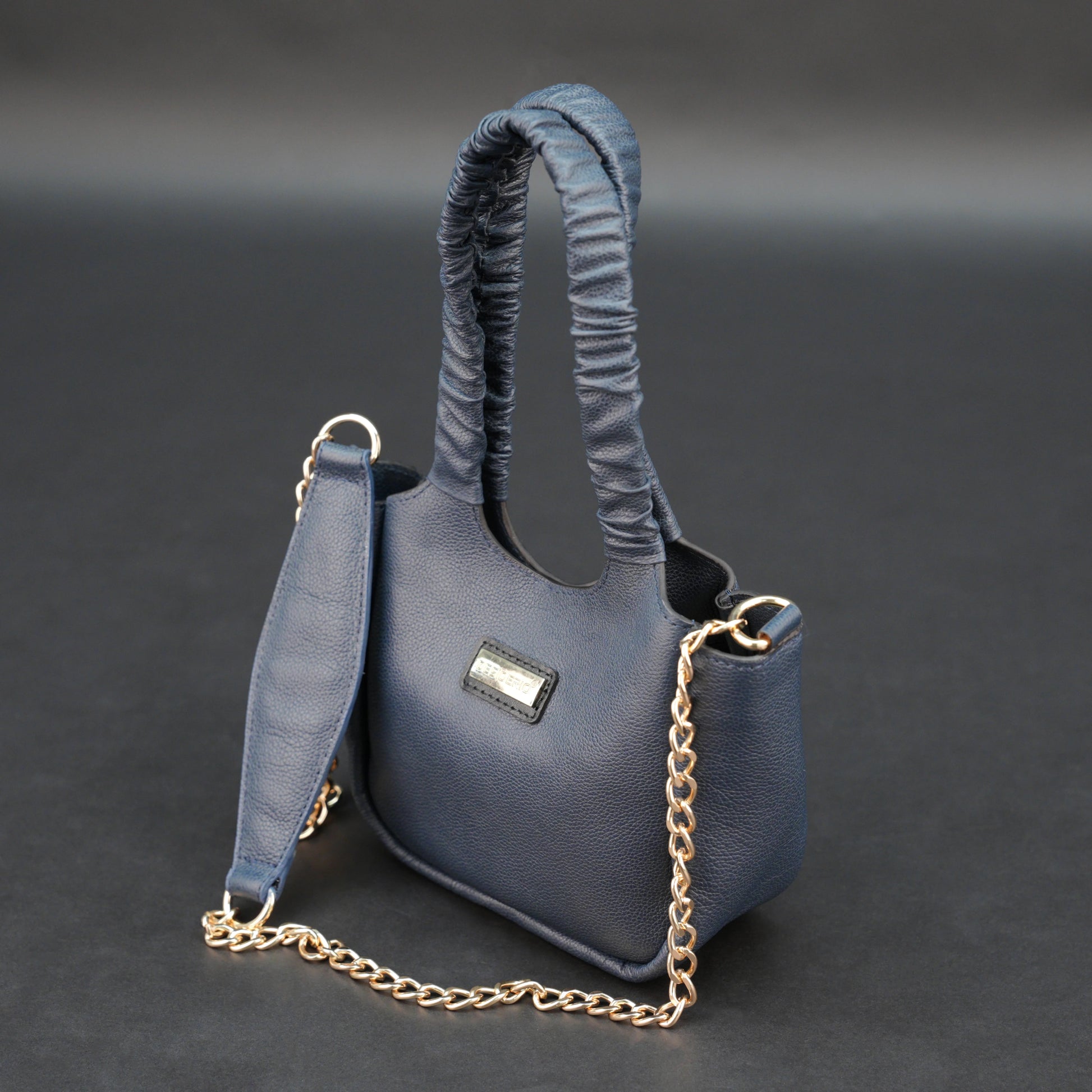 Deep blue premium cow leather bag with shoulder strap, main compartment, and inner pocket.
