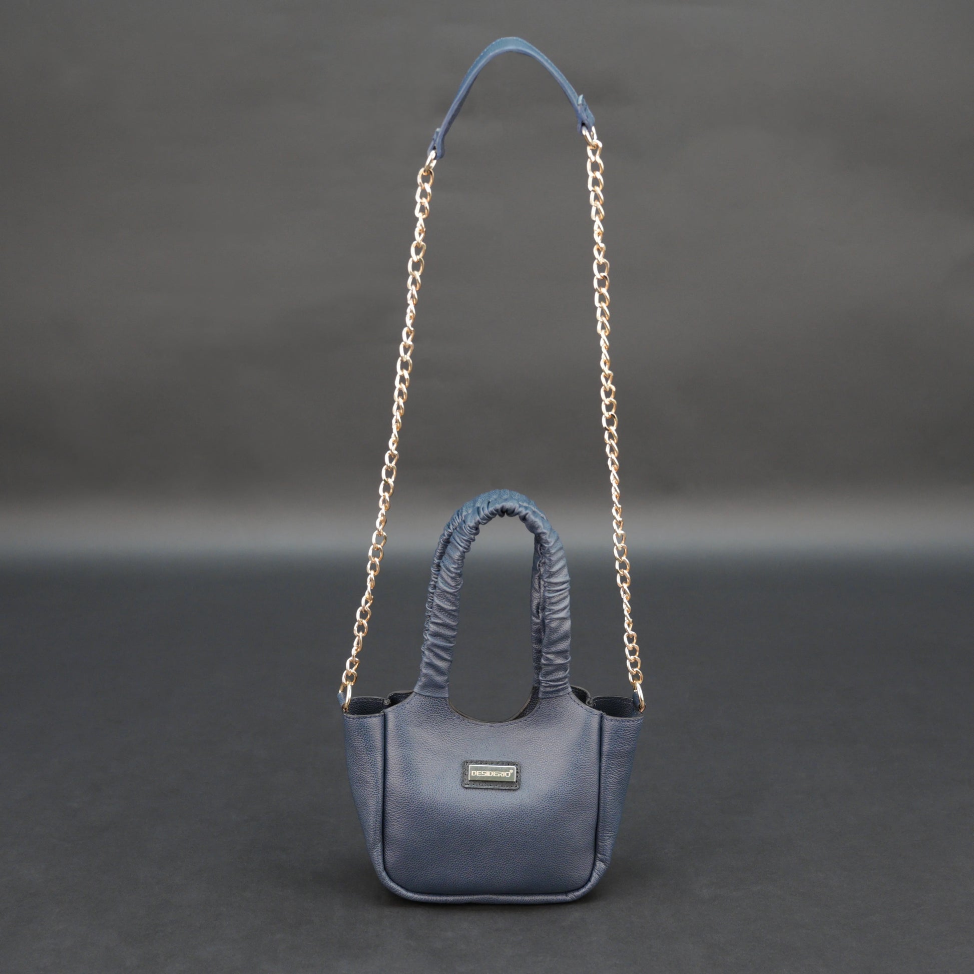 Deep blue premium cow leather bag with shoulder strap, main compartment, and inner pocket.