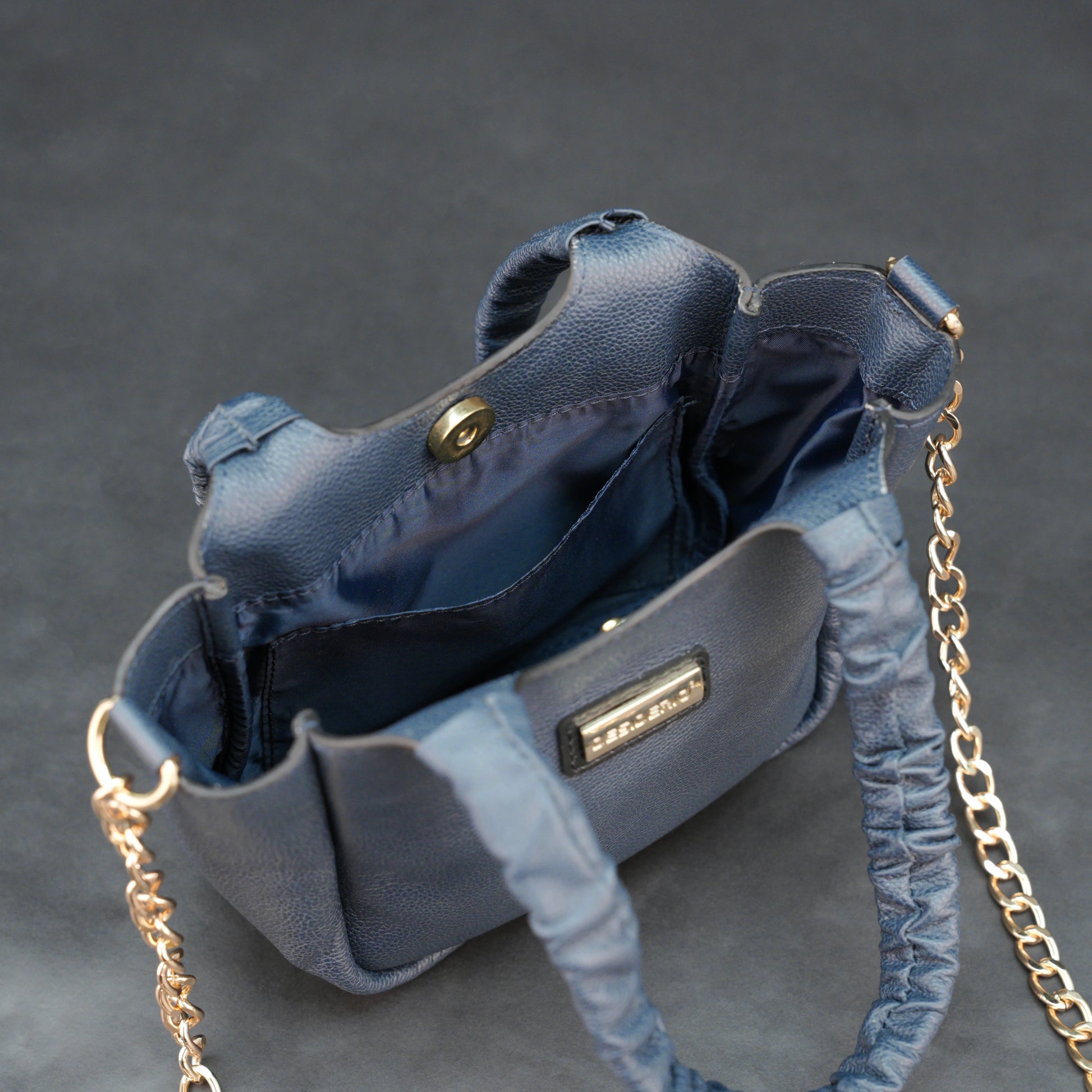 Deep blue premium cow leather bag with shoulder strap, main compartment, and inner pocket.