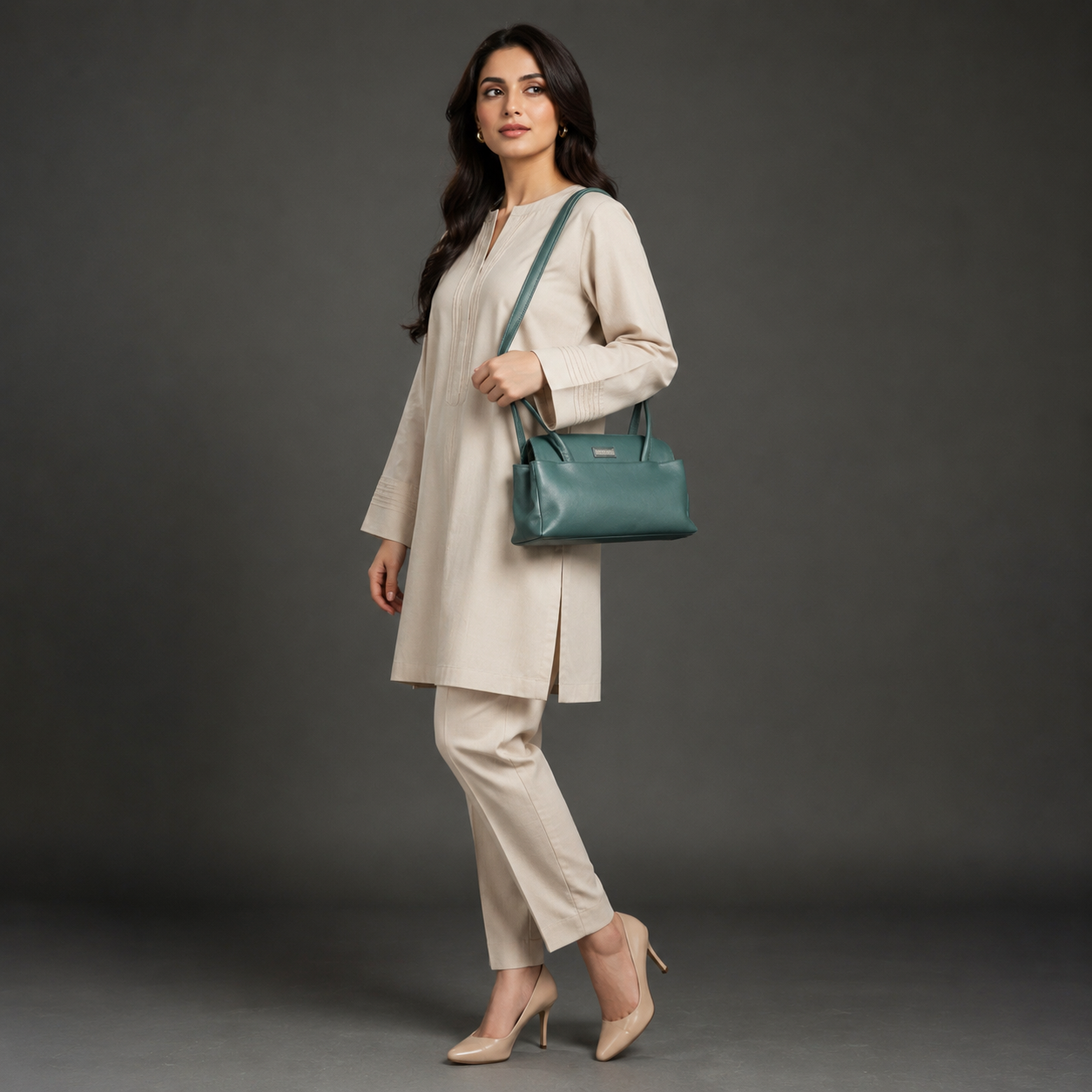 Deep jade cow Bamie leather bag with straps, dual compartments, and zipper pocket.