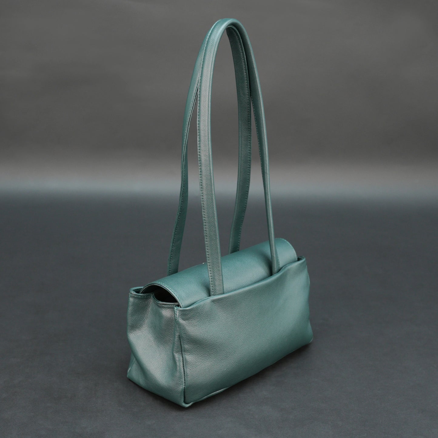 Deep jade cow Bamie leather bag with straps, dual compartments, and zipper pocket.